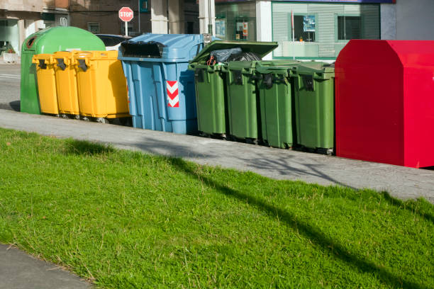 istock Row of multicolored garbage bins by the sidewalk for recycling. 1175549013