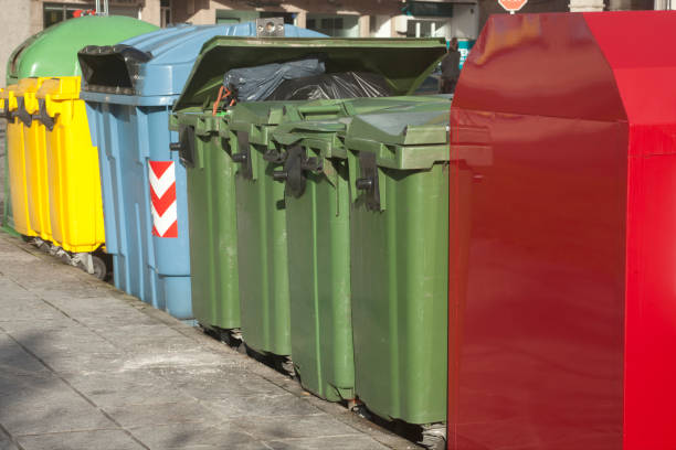 istock Row of multicolored  garbage bins by the sidewalk for recycling. 1175549025