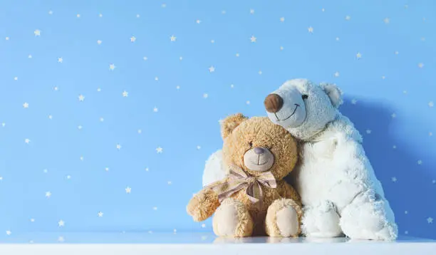 Photo of cute kids toys on the nightstand in blue nursery