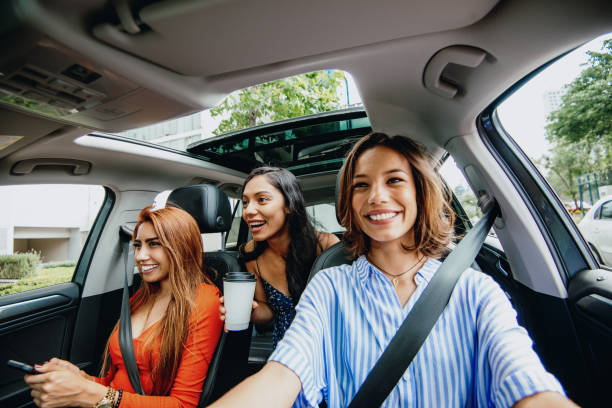 istock Three Latin women in car, going for road trip 1175550573
