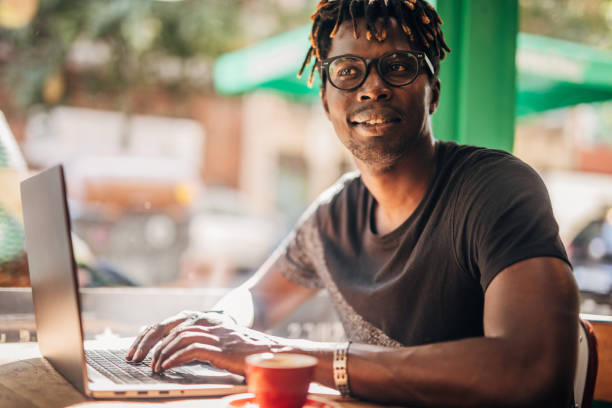 istock Man sitting in coffee shop and using laptop 1175550589