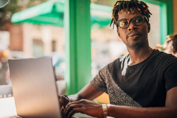 istock Man sitting in coffee shop and using laptop 1175550730