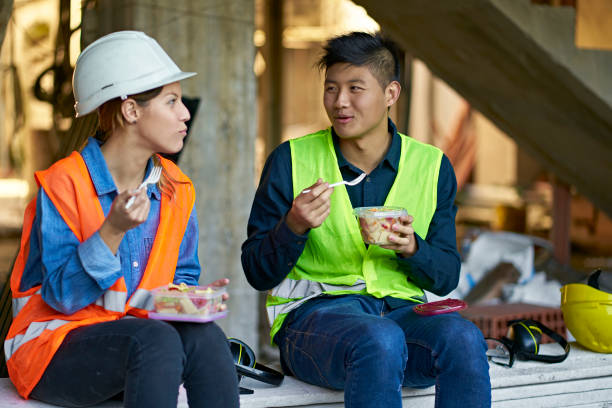 istock Male worker looking at coworker during lunch break 1175550928