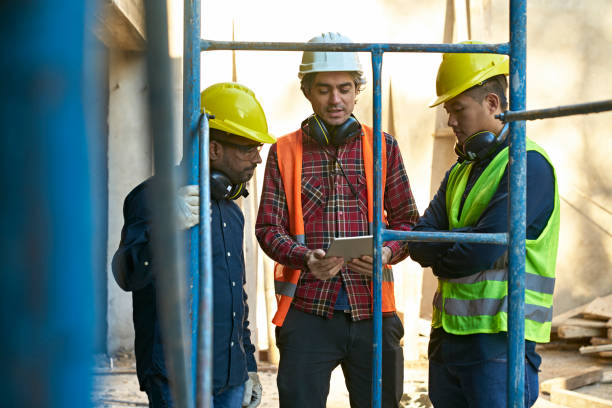 istock Civil engineers discussing by scaffolding at site 1175551181