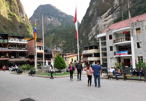 Scene Of Andes Mountain, Building Exterior, People Sitting Down, Standing, Walking Around And More At Aguas Calientes City Town Square In Cusco Peru South America