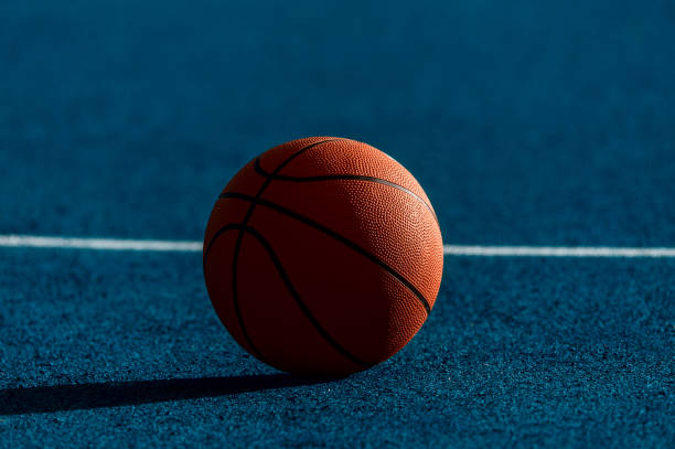 istock Orange Basketball ball on the blue surface 1175552358
