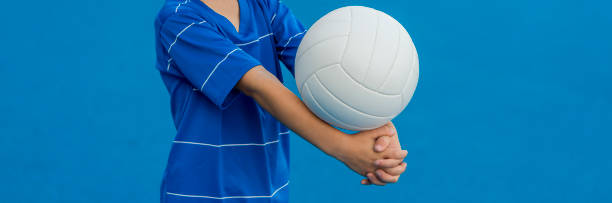 istock Boy playing volleyball isolated in blue. 1175552680