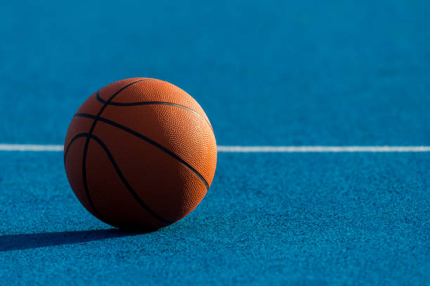 istock Orange Basketball ball on the blue surface 1175553709