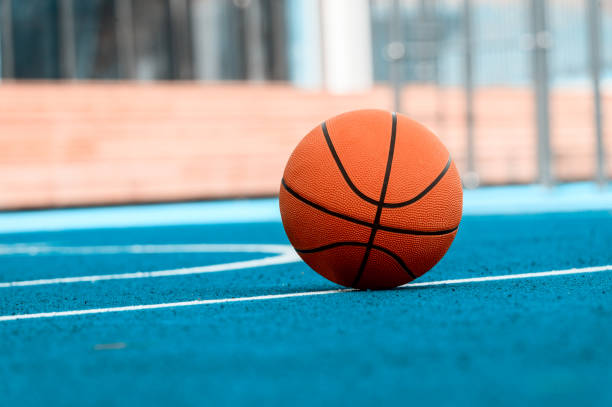 istock Orange Basketball ball on the blue surface 1175553752