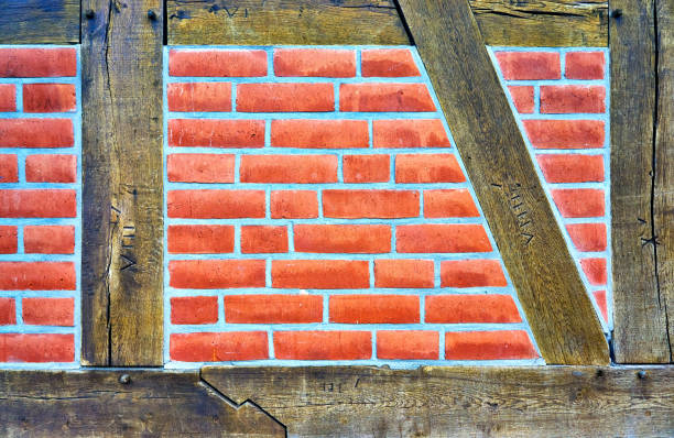 Old half-timbered made wooden with red bricks as background.