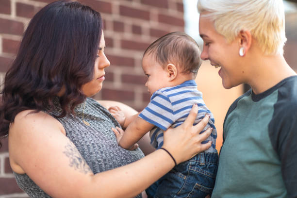 istock Young same sex couple with baby 1175554131