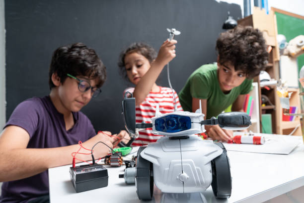istock Three Children Working On Robotics In Front Of Blackboard 1175554341