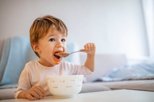 istock Cute child little boy eats healthy food vegetables 1175558639