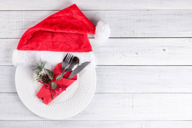 istock Christmas table setting with an empty plate and red Santa hat 1175558720