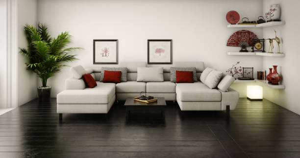 Three seater green velvet upholstered couch or sofa with long floor fringe and geometric square cushions isolated on white