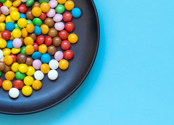 istock chocolate dragee candies in a plate on a colorful background 1175559105