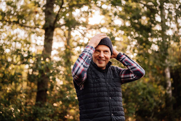 Man walking in autumn in hat and winter clothing\nCasual real man portraits outdoors