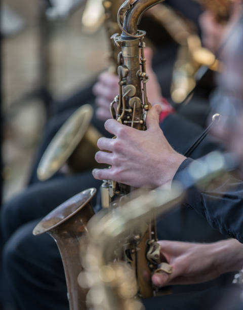 istock Saxophone and hand playing the instrument in a larger band 1175561390