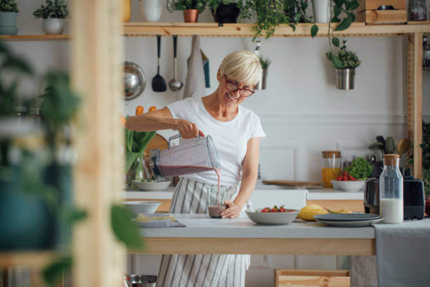 Woman Pouring Smoothie in Glass