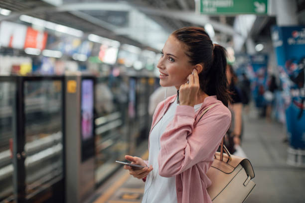 Young Woman Using Cell Phone and Earphone