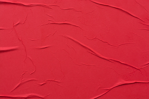 Red crumpled sheet of paper close-up.