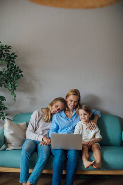 istock Mother and Children Looking at Laptop 1175563881