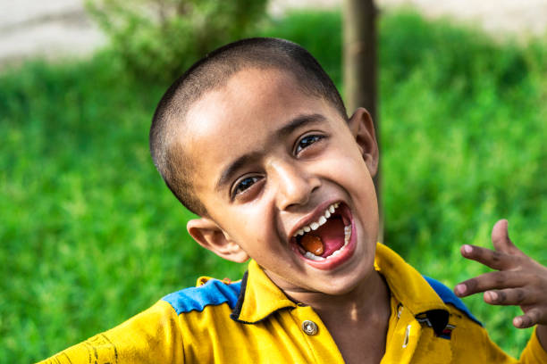 istock a poor villager boy is smiling and going to school 1175567164