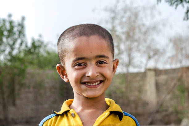 a poor villager boy is smiling and going to school