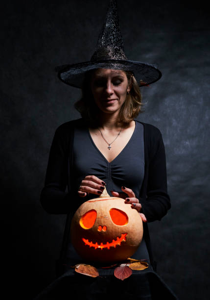 istock Woman in black with pumpking 1175567435