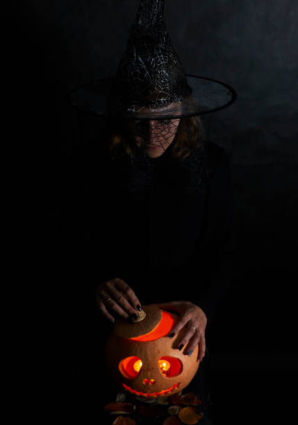 istock Woman in black with pumpking 1175567457