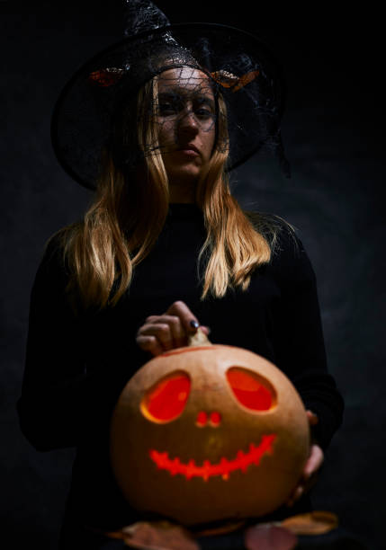 istock Woman in black with pumpking 1175567483