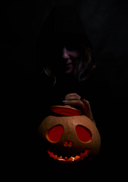 istock Woman in black with pumpking 1175568127