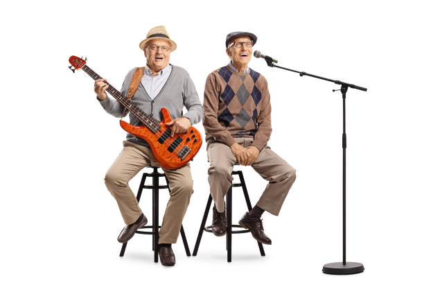 istock Two senior men sitting with an electric guitar and a microphone 1175568986
