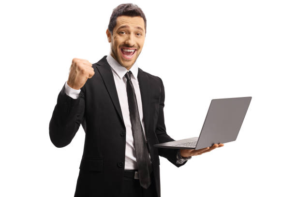 istock Young businessman gesturing yeah and holding a laptop computer 1175571086