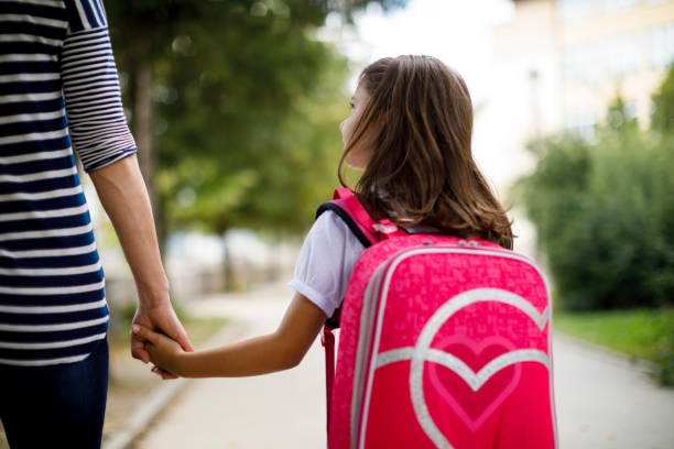 istock Mother taking her daughter to school 1175573757