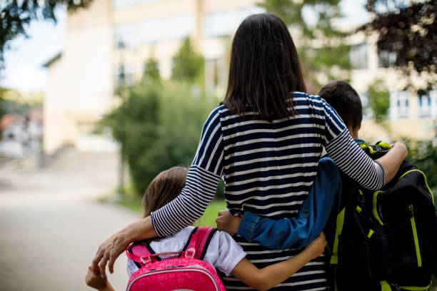 istock Mother taking kids to school 1175573881
