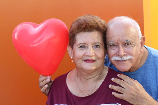 istock Happy elder couple holding heart shaped balloon 1175573960