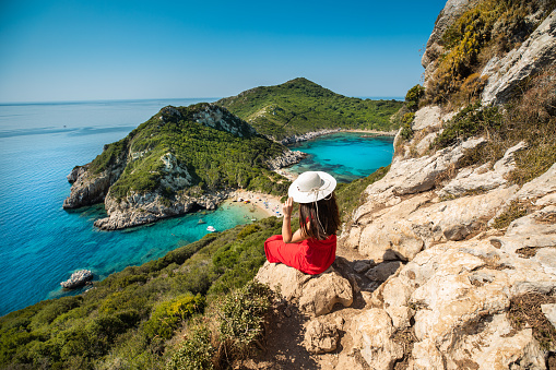 Young woman enjoy the holiday view of Porto Timoni, Corfu in Greece.