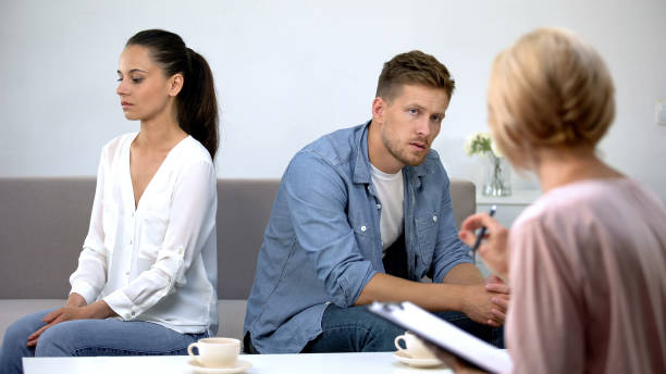 istock Couple turned from each other sitting at psychology therapy working on relations 1175583441