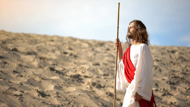 istock Jesus with closed eyes enjoying sun, mental talk with Father Lord, blessing 1175583490