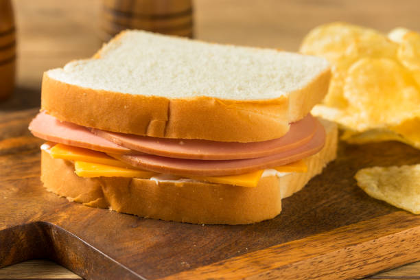 Homemade Bologna and Cheese Sandwich Homemade Bologna and Cheese Sandwich with Chips baloney photos stock pictures, royalty-free photos & images