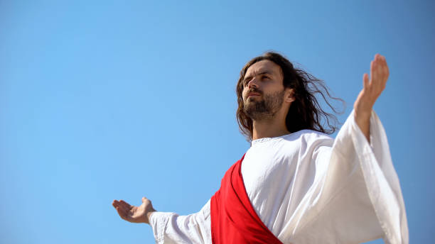 istock Saint man looking at sky with opened hands, Jesus resurrection and ascension 1175583622