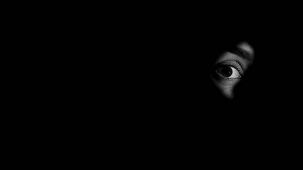Persons eye looking through keyhole, darkness, intrusions into privacy, secret Persons eye looking through keyhole, darkness, intrusions into privacy, secret woman spying through a keyhole stock pictures, royalty-free photos & images