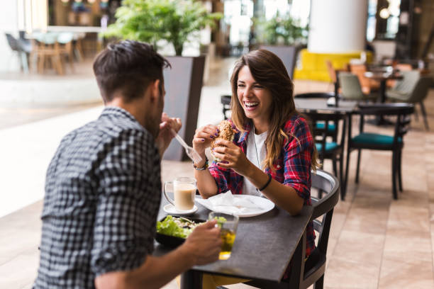 istock Happy loving couple enjoying breakfast in a cafe 1175583719