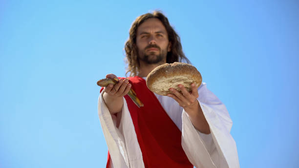 jesus showing fish and bread, biblical story, miracle about feeding thousands - miracle food imagens e fotografias de stock