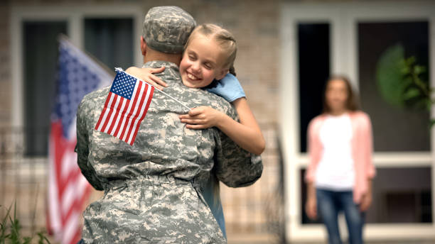 cheerful daughter hugging father soldier, long awaited meeting, homecome - military armed forces family veteran imagens e fotografias de stock