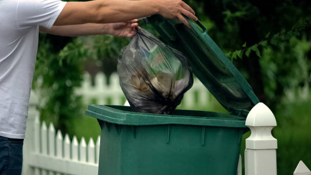 istock Male citizen throwing garbage in trash can, preventing littering, environment 1175585330