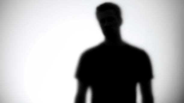 istock Silhouette of male looking at camera through white glass, statistic template 1175585906