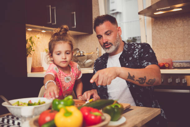 istock Father and daughter cooking 1175587741