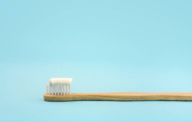 istock Eco friendly wooden Toothbrush with toothpaste isolated on blue 1175589880